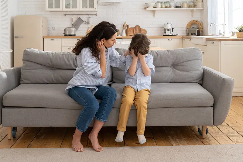 Mom and son on couch fighting and isolated from Parental Alienation Austin TX